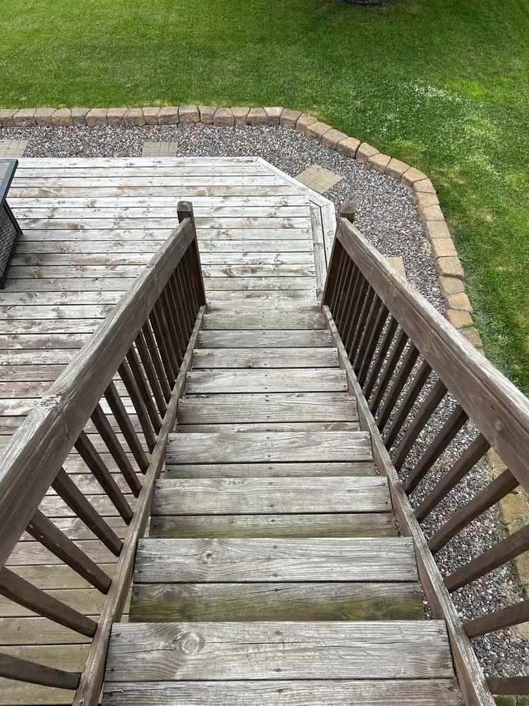 Weathered, unfinished deck stairs before staining