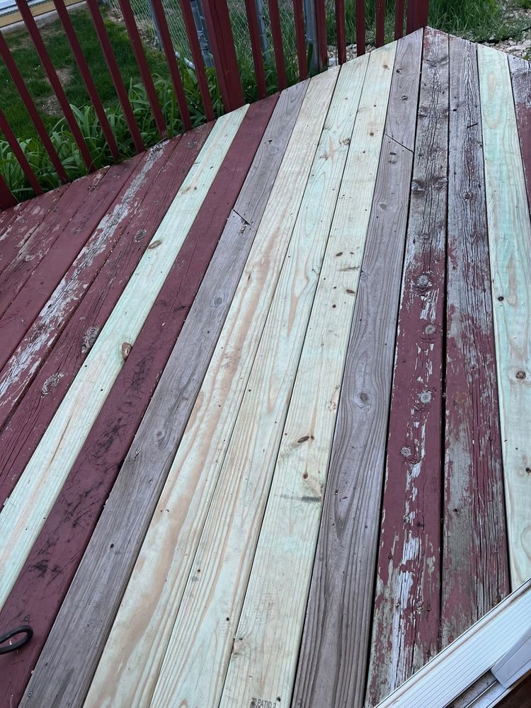 Deck mid-repair, with replacement boards set in beside the old stained decking