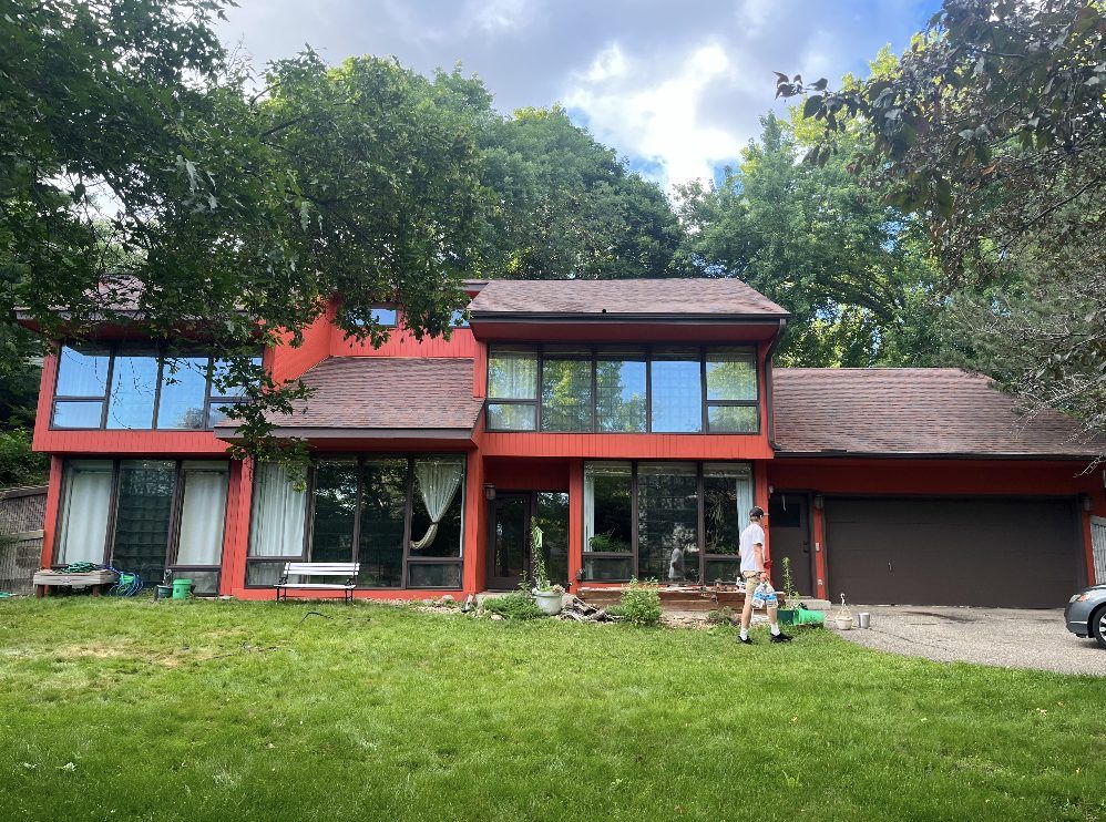 The same house after a bold red exterior repaint