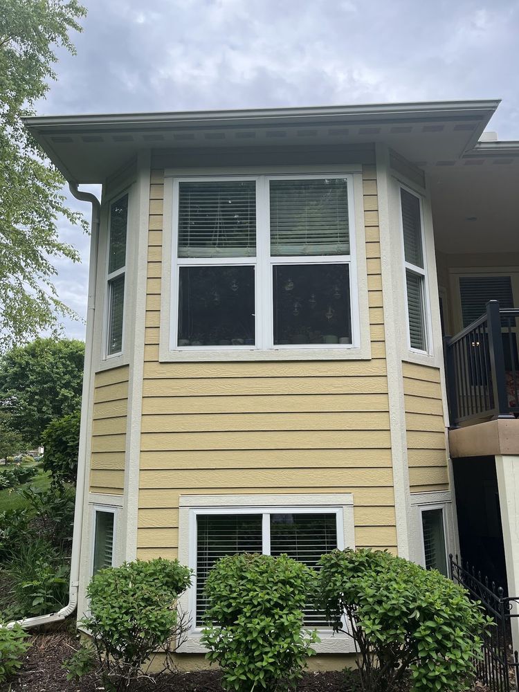 Corner windows on a yellow home with white trim