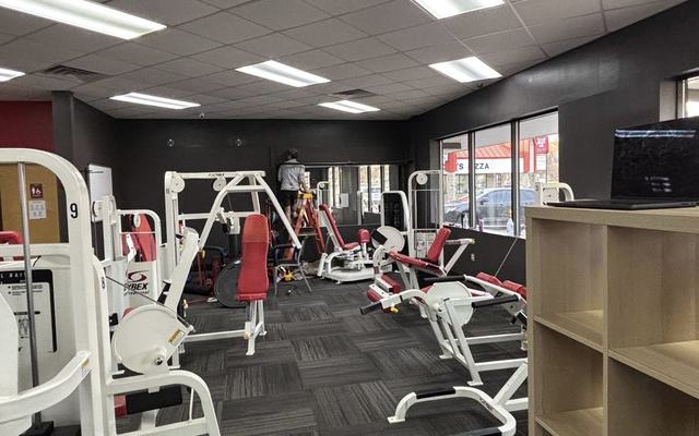 Dark charcoal interior walls in a fitness studio, a genuinely high-traffic space